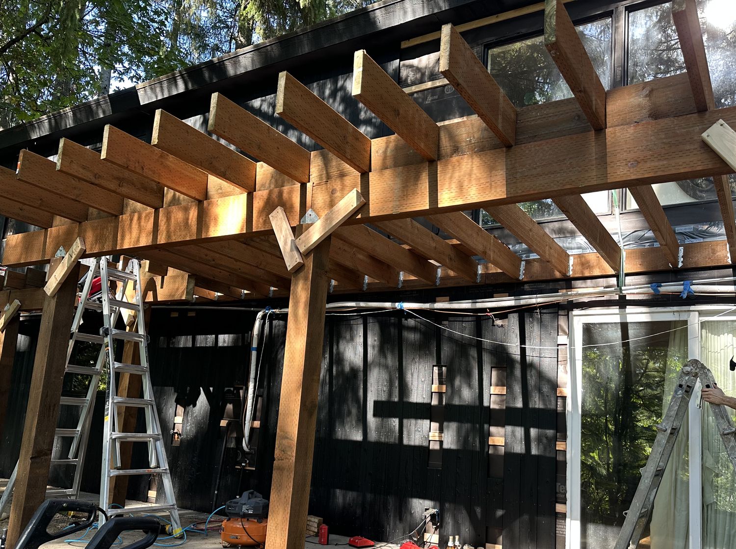 Heavy timber beams and rafters with steel connectors forming a covered walkway